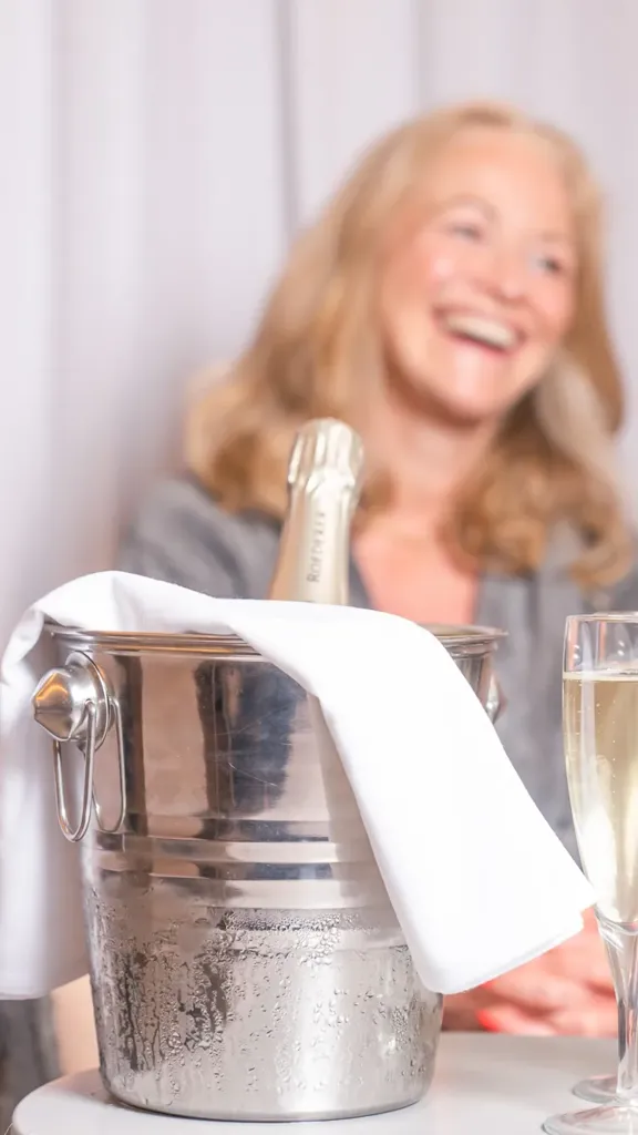 2 woman enjoying a bottle of champagne in a cooler